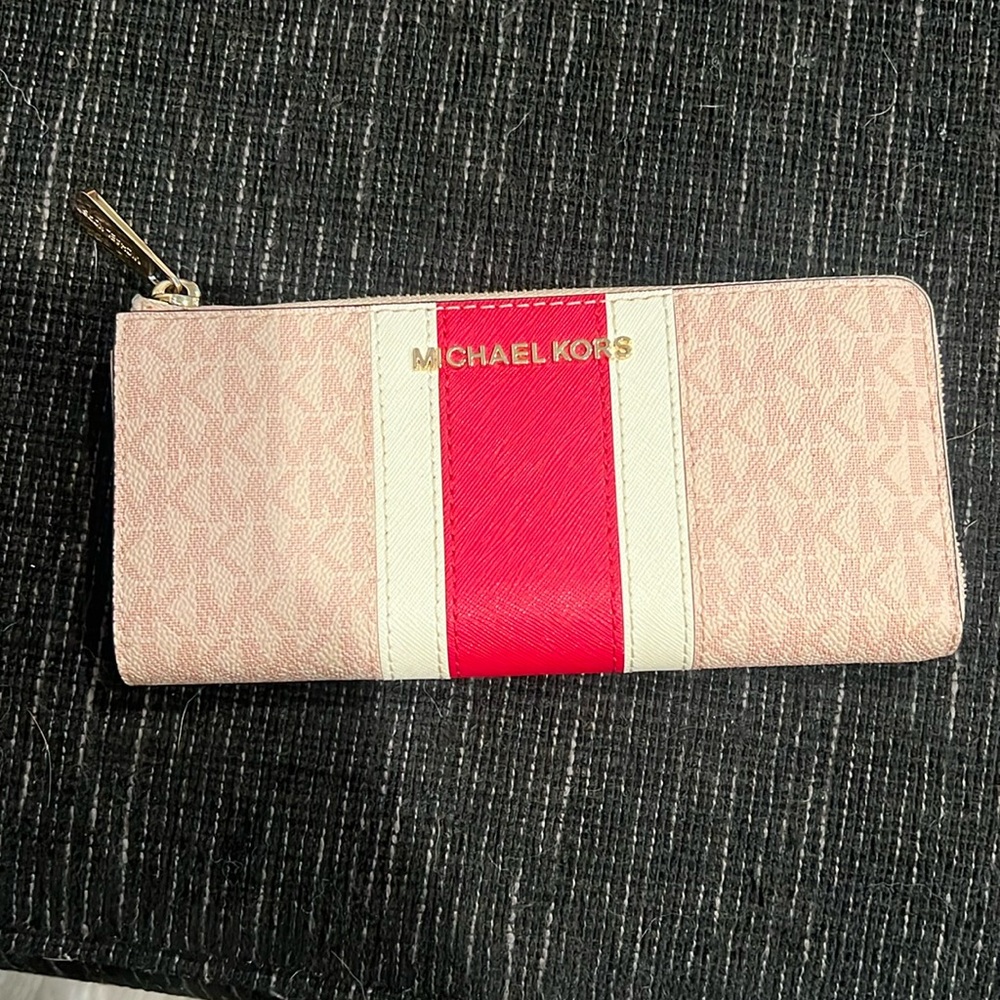 A pink Michael Kors wallet was a red stripe in the middle.